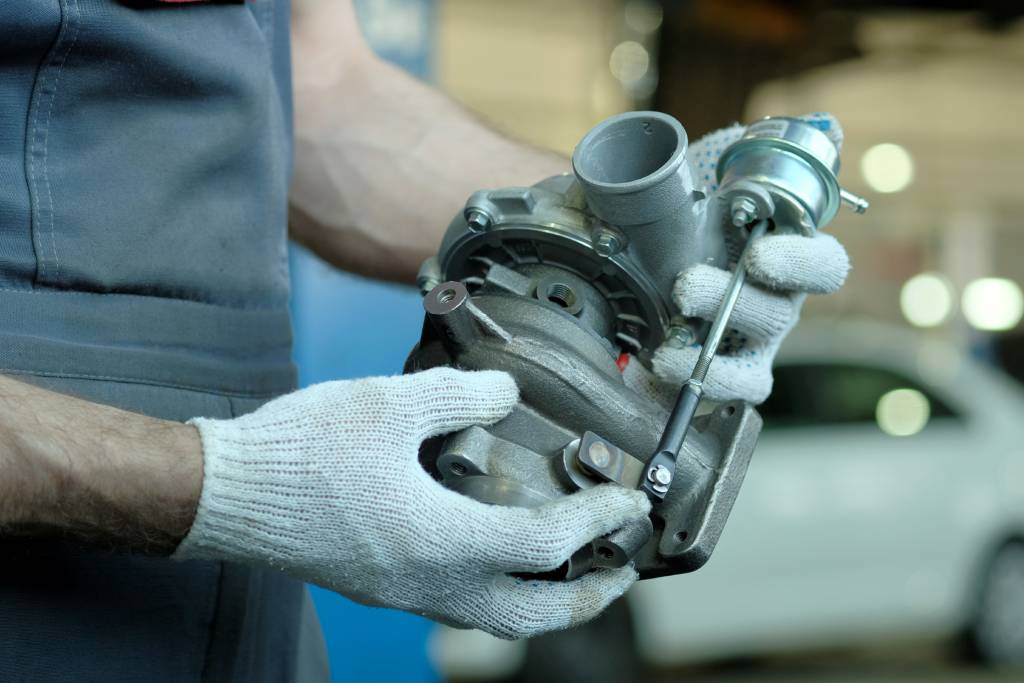 Mechanic holds a car turbocharger