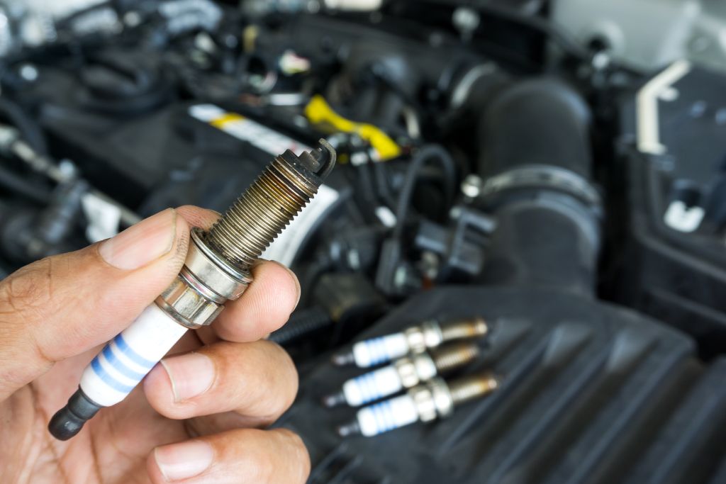 Mechanic holds used spark plug